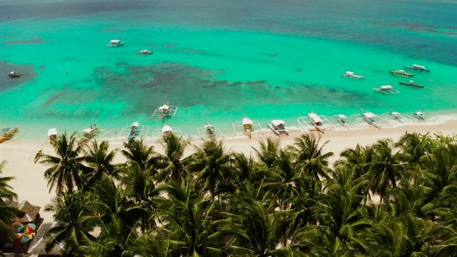 Beautiful tropical island in sunny weather, view from above. Daco island, Philippines. White sandy beach and turquoise lagoon.