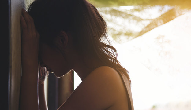 Sad Depressed Woman Suffering From Family Life. Women Sitting In Dark Room Cryng, Palm Close Her Face. Young Beautiful Women Thinking How To Solve Problem.