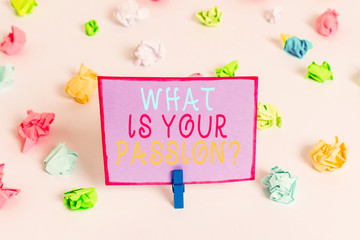 Writing note showing What Is Your Passion Question. Business concept for asking about his strong and barely controllable emotion Colored crumpled paper empty reminder white floor clothespin