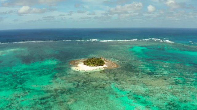 Guyam island, Siargao, Philippines. Small island with palm trees and a white sandy beach. Philippine Islands.