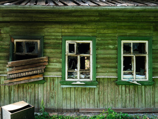 Boarded-up Windows at the old wooden house after the fire