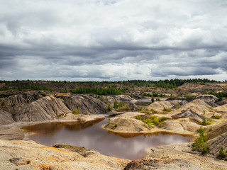 Obraz premium Natural clay quarry. Red lake because of the clay