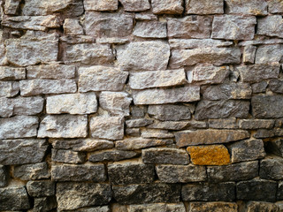 The wall of old stone gray. Solid wall made of rectangular stones