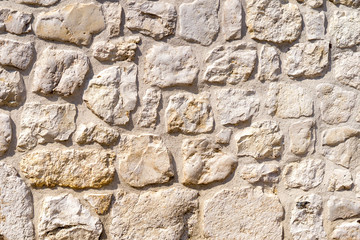 Old, damaged by time, stone wall. Natural background for designers.