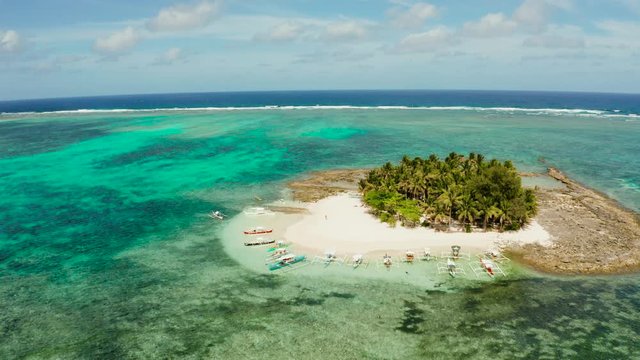 Guyam island, Siargao, Philippines. Small island with palm trees and a white sandy beach. Philippine Islands.
