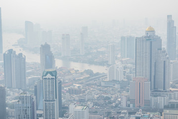 Obraz na płótnie Canvas Air pollution in Bangkok with PM2.5 air-quality index (AQI) reached dangerous level with dust and smog in hazy sky, threatening to public health, rooftop view