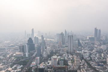 Fototapeta premium Air pollution in Bangkok with PM2.5 air-quality index (AQI) reached dangerous level with dust and smog in hazy sky, threatening to public health, rooftop view