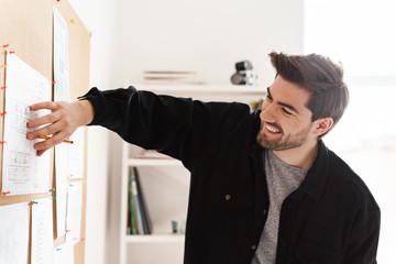 Fototapeta premium Happy cheerful professional man architect in office work with projects on desk.