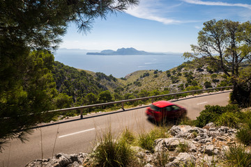 Road to Cap Formentor with red motion blurred car