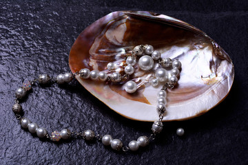 Pearls in a shell on a black background