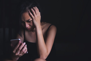 Young women seriously reading bad news from mobile phone. Women got bad news from her boyfriend.