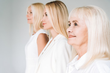 selective focus of three generation women isolated on grey
