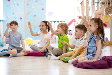Preschool children play on speech therapy lesson in kindergarten or primary school