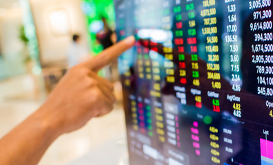 Stock exchange market business concept with selective focus effect. Display of Stock market quotes with finger pointing.