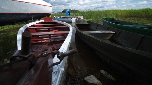 Old and New fishing wooden Row Boats driffting in the lake on Summer Sunny day