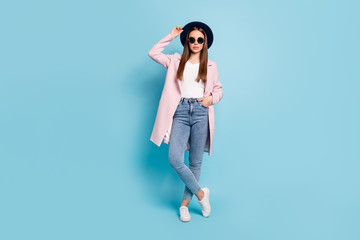 Full size photo of charming classy worker in eyeglasses eyewear touch her modern cap ready to decide work decision wear topcoat denim jeans isolated over blue color background