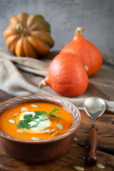 Pumpkin soup on a dark wooden background.