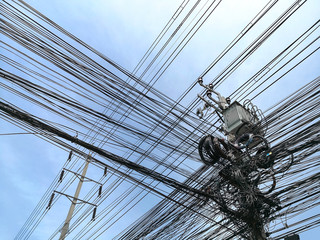 Tangle of Electrical cables and Communication wires on electric pole.