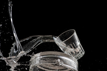 a glass falls on an ashtray and breaks it