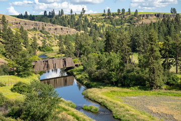 Fototapeta na wymiar Manning-Rye Covered Bridge in the Palouse region of Washington State, spans the Palouse river in Colfax, WA