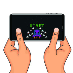 hands holding a phone with 8 bit game. Pixel game on the phone