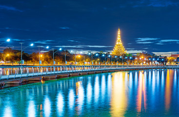 In Khon kaen twilight time at Bueng Kaen nakhon with Wat Phra Mahathat Kaen Nakhon, travel concept, lifestyle with copy space.