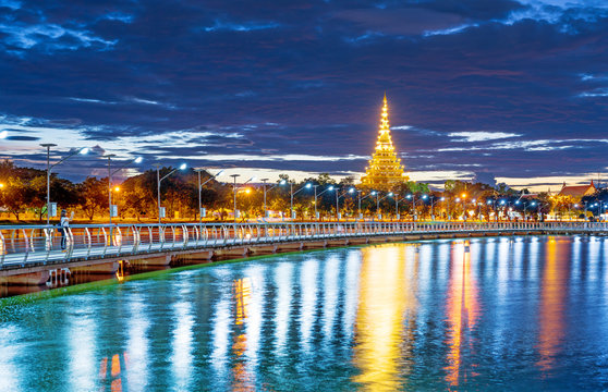 In Khon kaen twilight time at Bueng Kaen nakhon with Wat Phra Mahathat Kaen Nakhon, soft focus, travel concept, lifestyle with copy space.