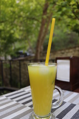 glass of juice on table in garden