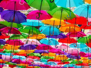 Fototapeta na wymiar Colorful umbrellas used as shade cover over park