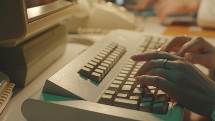 Scientist typing on a keyboard in a vintage lab