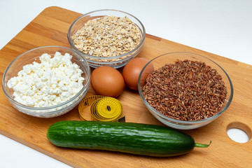 cereals, measuring tape, farm cottage cheese eggs carrot close up on white background protein healthy diet fat free concept eco product sports nutrition