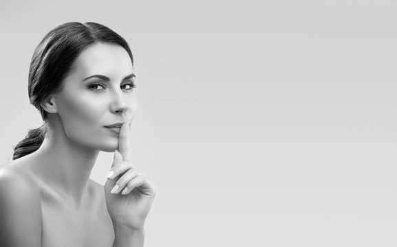 Woman keeping finger on her lips
