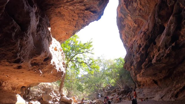 Unrecognizable hikers visiting in Tunnel Creek Kimberley Western Australia