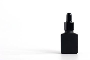 Mockup product of black serum bottle on white background with copy space