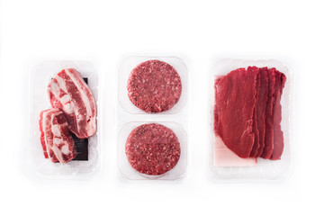 Different types of meat packaged in plastic isolated on white background. Top view