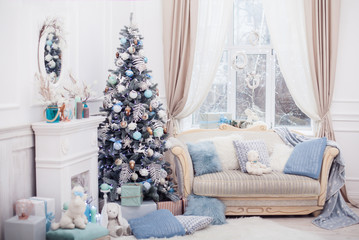 Christmas tree decorated with lovely ornaments and classical style fireplace in white room. New year scene.