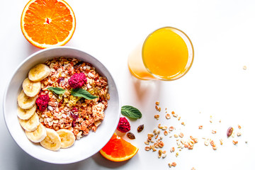 Breakfast with oatmeal and orange juice on white background