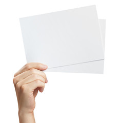 Hand holding two small sheets of paper (tickets, flyers, invitations, coupons, banknotes, etc.), isolated on white background