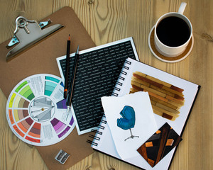 Flat lay of Interior designer work space with sketches, tools and colour chart