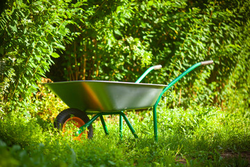 Garden cart in the garden. Garden tools.