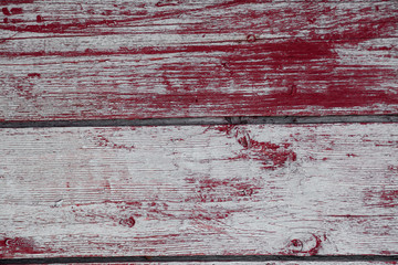 Red-gray wooden background. The texture of a tree painted in gray and red. Concept, blank, photo background with wood closeup.