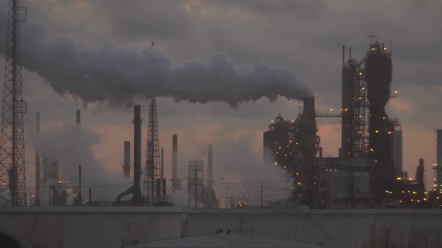 Tower Emits Large Thick Grey Smoke Cloud At Refinery Factory