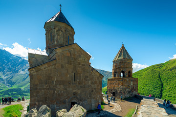 Fototapeta na wymiar Beautiful Trinity Church above the village of Gergeti in Georgia on the mountain