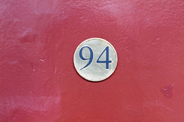 Street number sign on the wall