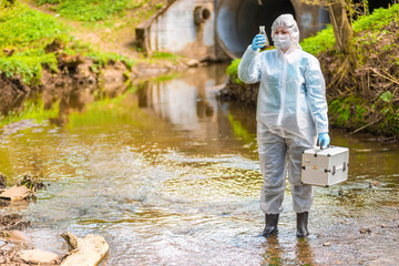 Woman with flask for expertise. Environmental pollution concept