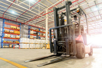 Forklift truck loader. Huge distribution warehouse with high shelves background.