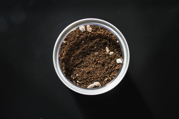 Closeup pile of soil and gravel in glass on black background
