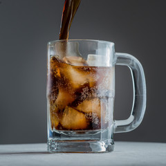 refreshing glass mug of cola soda on ice