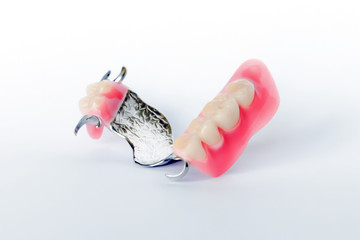 clasp prosthesis with clam fixation on the upper jaw isolated on a white background © Vladyslav Senchenko