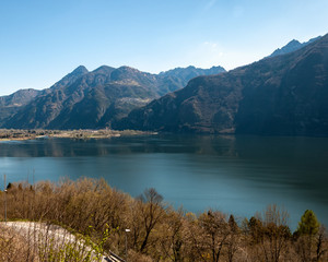 Panorama of Lake Idro from the town of Anfo, with a tourist and fishing port, a tourist destination for holidays at the lake, at the foot of the Alps immersed in unspoilt nature.